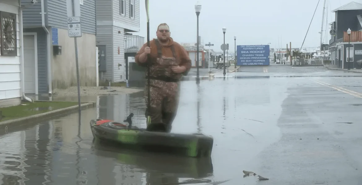 Flooded street in Ocean City with cars driving slowly through standing water during a nor’easter