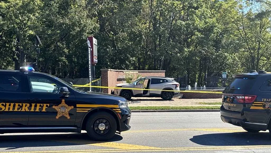 Investigators work at a Hamilton Avenue sidewalk crash scene where an SUV struck a pedestrian