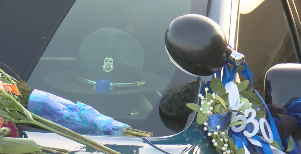 Flowers and a patrol car tribute at Bradley Ritger’s visitation in Chippewa Falls