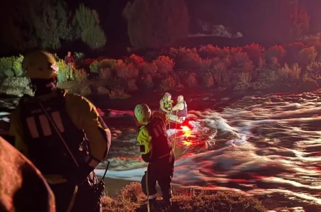 A National Guard swift-water rescue team responding near flooded water in San Miguel County
